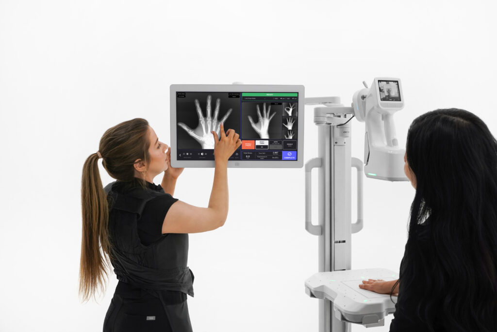 Physician is showing the hand X-rays to patient.