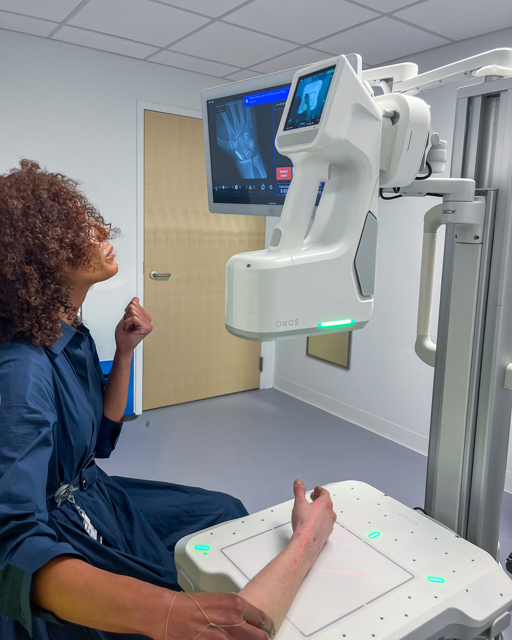 Dr. Youssra Marjoua evaluating a wrist X-ray taken by MC2 Clinic at The Cleveland Clinic.