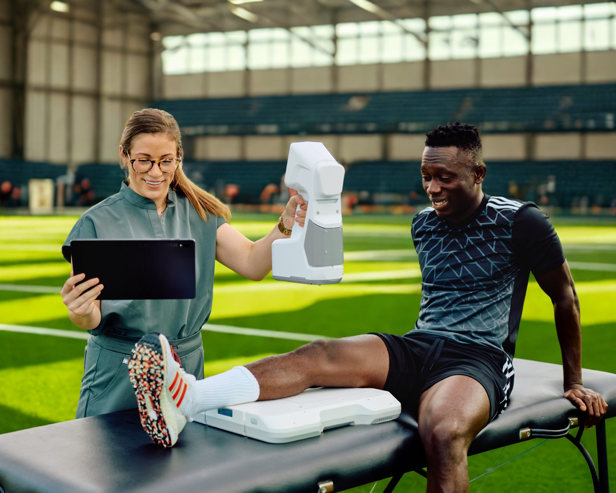 taking an x-ray with an MC2 portable xray on a a training room table at an indoor soccer field