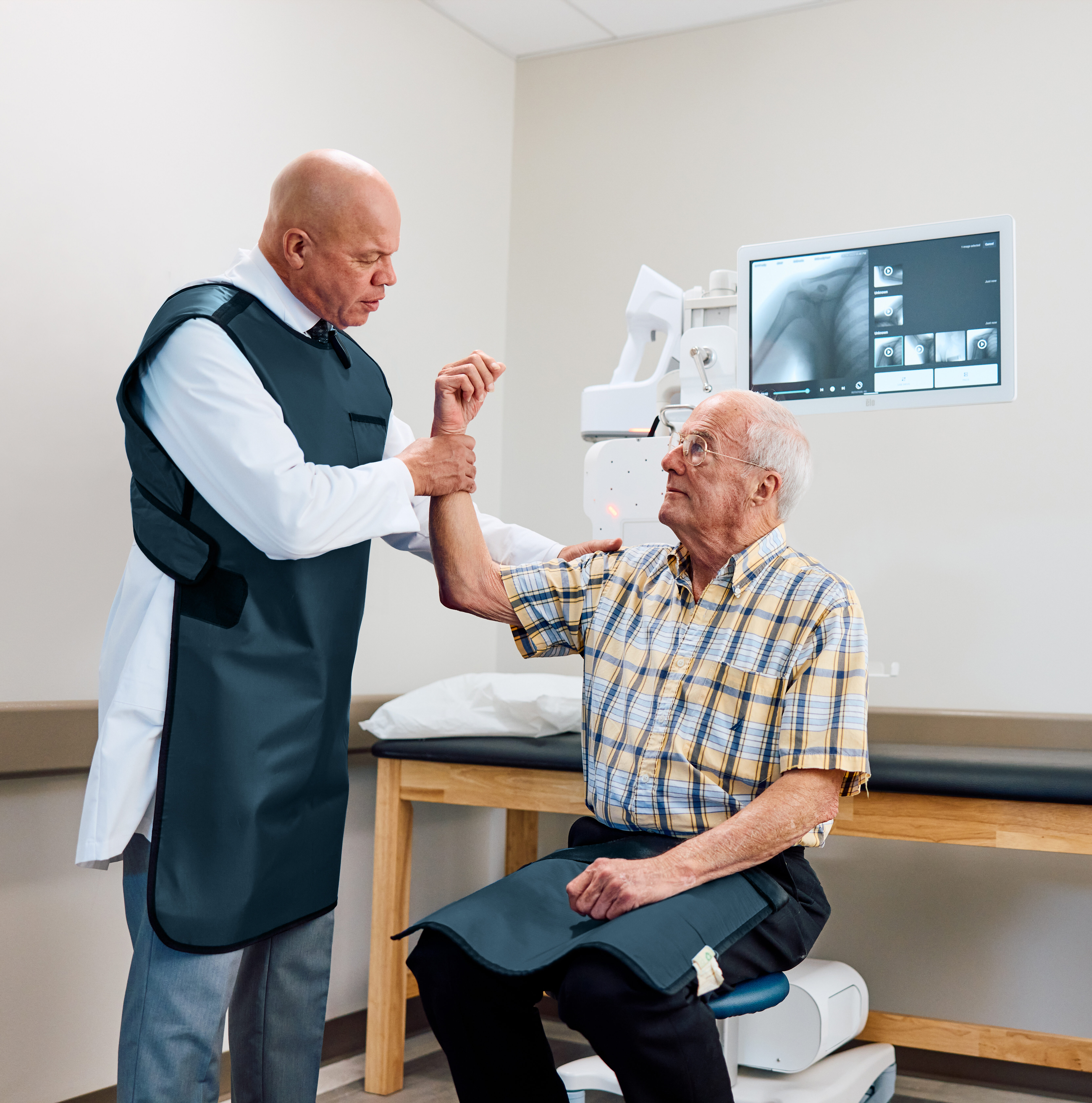 Doctor is assessing a shoulder injury after taking an X-ray with the MC2 portable imaging device.