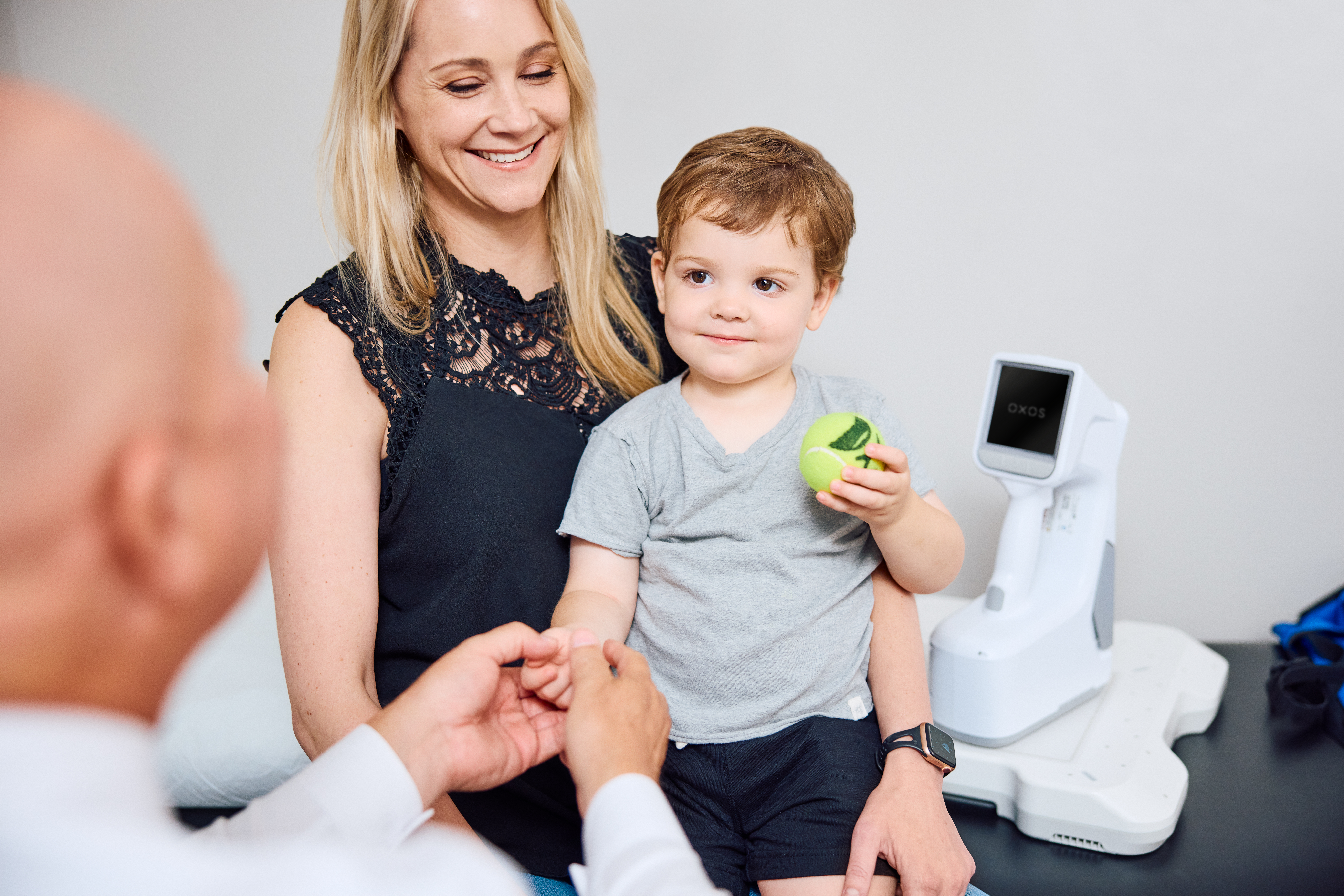 Pediatric orthopedic surgeon is in a consult of a little boy with the MC2 portable X-ray in frame.